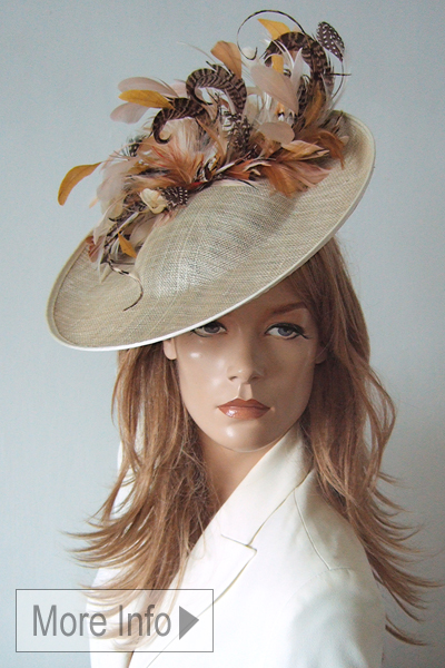 Champagne Gold Feather Hat Hatinator 2025. Champagne Gold Hats for Cheltenham Races 2026, Champagne Gold Mother of the Bride Hats 2026. Champagne Gold Hats for Royal Ascot 2026. Mother of the Bride Hat Hire 2026. Royal Ascot Hat Hire 2026. Designer Hats for Royal Ascot 2026. www.dress-2-impress.com