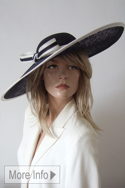 Navy Blue and White Royal Ascot Hat. Royal Ascot Hat Hire. Big Navy Blue and White Hats. Navy and White Mother of the Bride hats. Navy Blue Mother of the Bride hat Hire.
