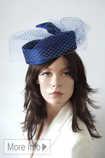 John Boyd Navy Pillbox Style Headpiece. Royal Ascot Hat Hire 2026. Amazing Hats for Royal Ascot 2026. Navy Blue Royal Ascot Hats. Hat rental for Royal Ascot 2026. What to wear for Royal Ascot 2026.